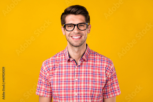 Photo of young cheerful business man happy positive smile agent manager isolated over yellow color background © deagreez