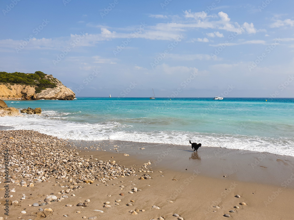 Rocky sandy beach, coastline with turquoise sea, wave splash, Catalonia, Spain