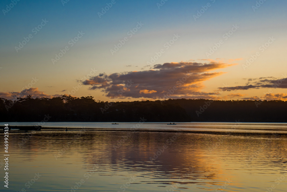 Beautiful sunset on tranquility lake river ocean sea. Water reflections stunning nature background
