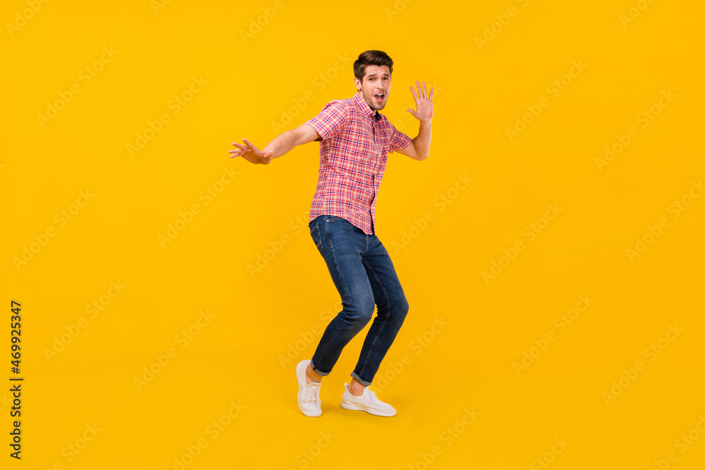 Full length body size view of attractive cheerful funky carefree guy dancing having fun isolated over bright yellow color background