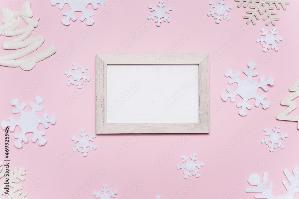 Christmas composition with white decorations on a pink background. Empty white frame with place for text. Christmas pattern. Flat lay, top view, copy space, mock up Christmas composition with white decorations on a pink background. Empty white frame with place for text. Christmas pattern. Flat lay, top view, copy space, mock up