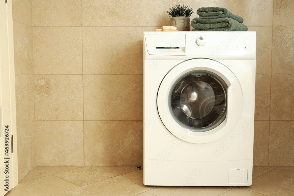 Concept of housework with washing machine in bathroom Concept of housework with washing machine in bathroom