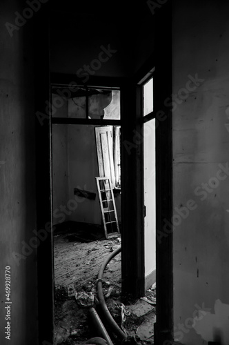Natural light enters in an abandoned building and ruins in black and white 