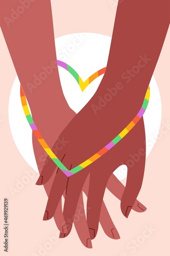 hand of LGBT women holding together with rainbow,  symbol of love and heart shape; concept of LGBT pride, LGBTQ people, lgbt+ rights campaign, same sex marriage, mixed couple, pride month