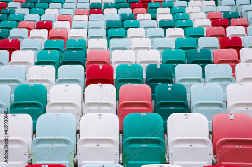 colored chairs at the football stadium. red green white