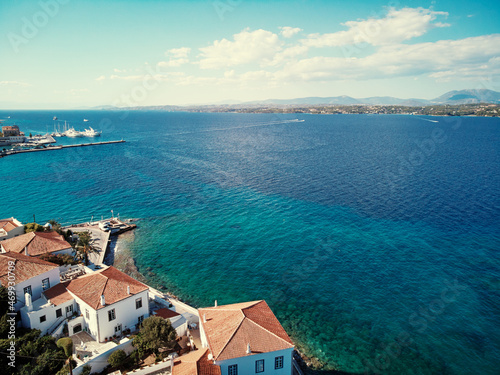 Fototapeta Naklejka Na Ścianę i Meble -  Aerial shot of Spetses Island coast in Greece. A famous tourist destination on the Aegean sea. Old town and harbour view.