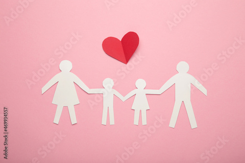 Happy paper family with hearts on pink background. Family day