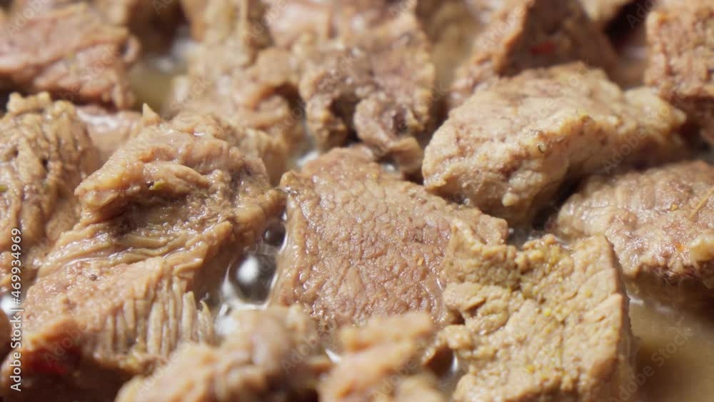 Cooking small pieces of beef close-up. Pan-fried stew, selective focus Cooking small pieces of beef close-up. Pan-fried stew, selective focus