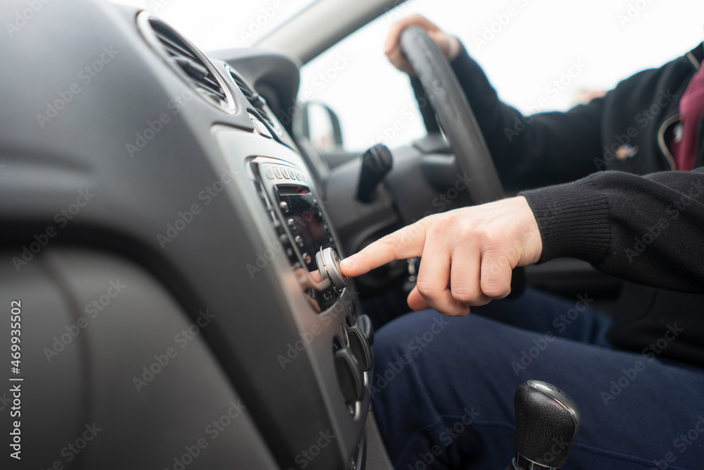 driver hand adjusting car multimedia, turn on radio