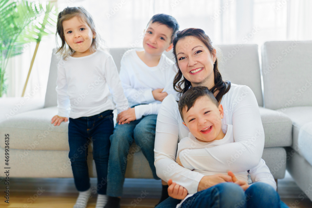 Loving mother with kids enjoying time together at home sofa Loving mother with kids enjoying time together at home sofa