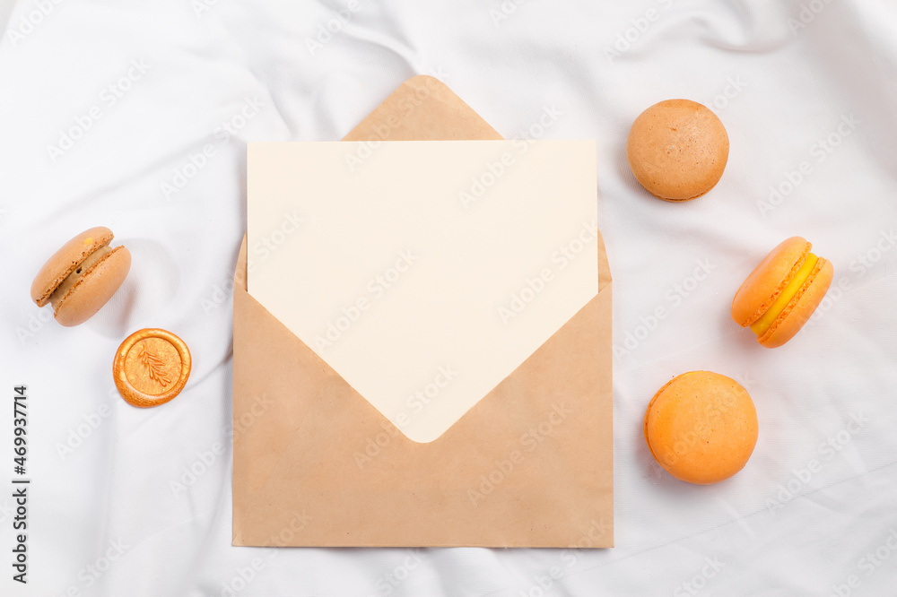 Colorful macarons and mockup letter on white textile Colorful macarons and mockup letter on white textile