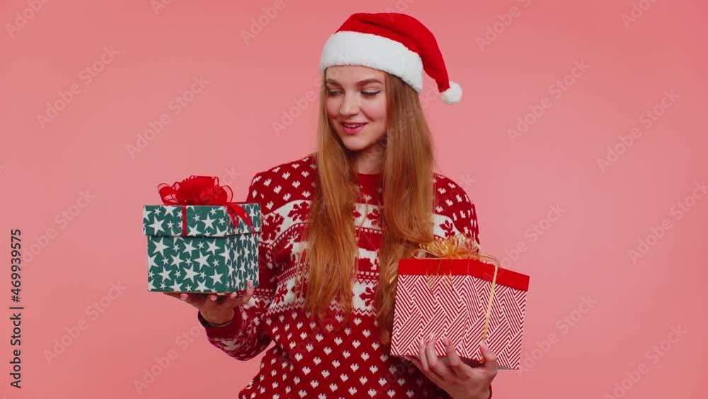 Woman in Christmas red sweater hat looking surprised at mount of boxes hands, excited by so many holiday gifts, lot of presents, have doubt which one to choose. Happy New Year presents shopping sale Woman in Christmas red sweater hat looking surprised at mount of boxes hands, excited by so many holiday gifts, lot of presents, have doubt which one to choose. Happy New Year presents shopping sale
