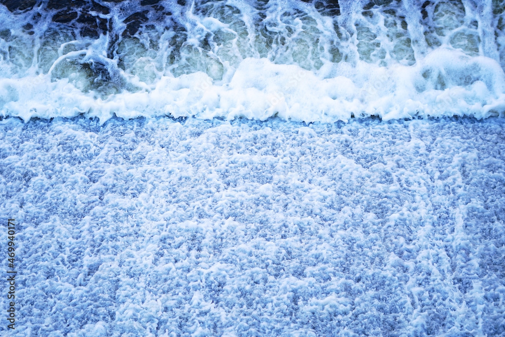 Fototapeta premium Blue water flows from a dam 