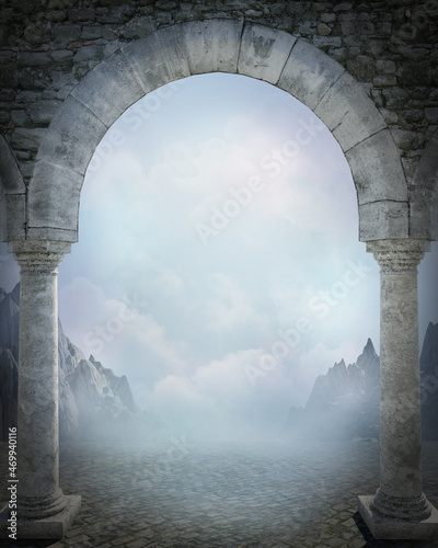 Fototapeta Old stone archway framing a beautiful dreamy view of mountains, soft billowing clouds and mist