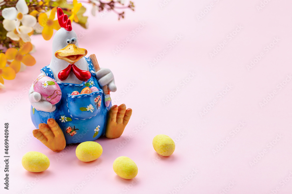 Easter decoration with colorful eggs, hen figurine and flowers.