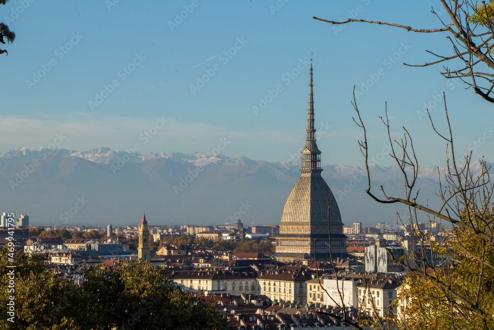 Turin (Turin, Italy): Sunrise cityscape with details of the Mole Antonelliana towering over the city, snowy mountain in the background
