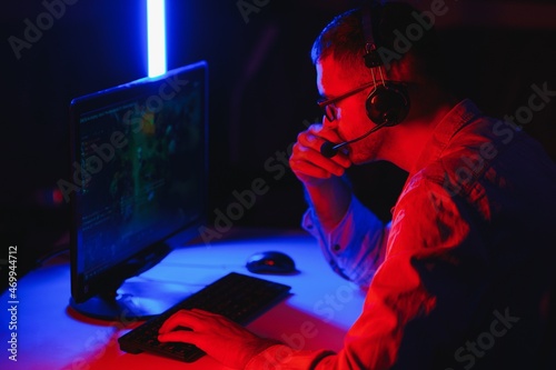 young man playing computer games on line