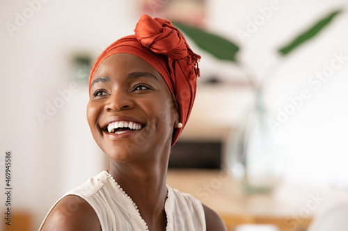 Joyful mature african woman laughing and looking away