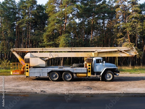 Construction lifter aerial work platform hoist based on an old truck came to cut trees