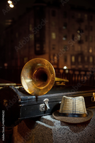 Trombone, men's hat and night city