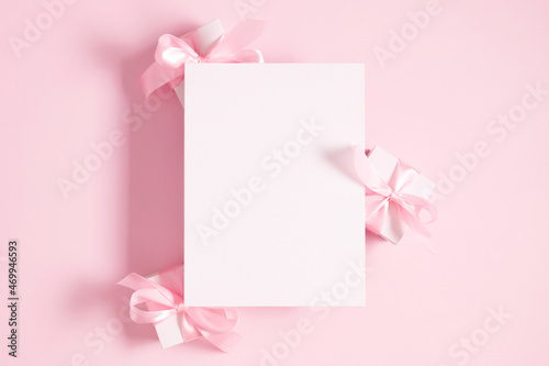 Blank white canvas mockup, gift on pastel pink background. Flat lay, top view, copy space © prime1001