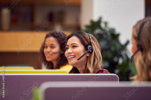 Obraz na plátne Mature Businesswoman Wearing Phone Headset Talking To Caller In Busy Customer Se