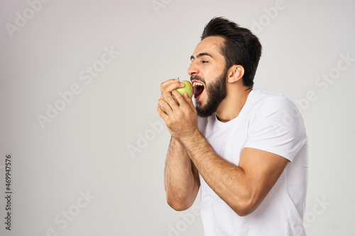 bearded man in white t-shirt apple health proper nutrition