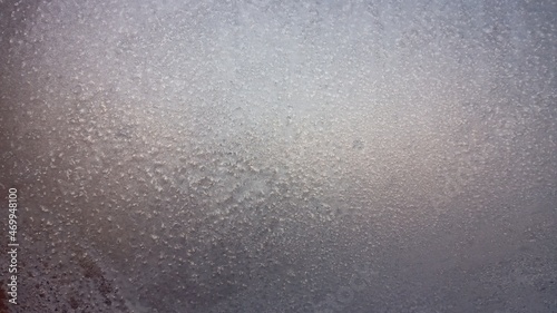 Frost texture on the window glass in winter. Ice Crystals in Winter Blue and Pink.