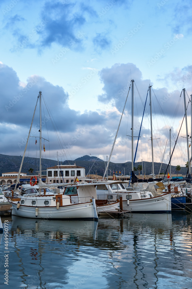 Port de Pollenca marina with sailing boats sailboats on Mallorca travel traveling holidays vacation portrait format in Spain