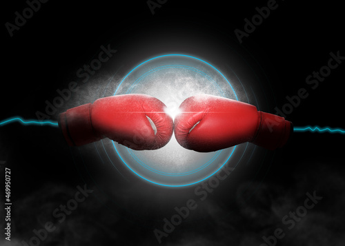Boxing gloves opposing each other against black background