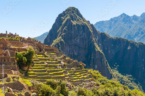 Huayna Picchu mountain peak in summer with inca housing architecture, Machu Picchu Historical Sanctuary, Peru.