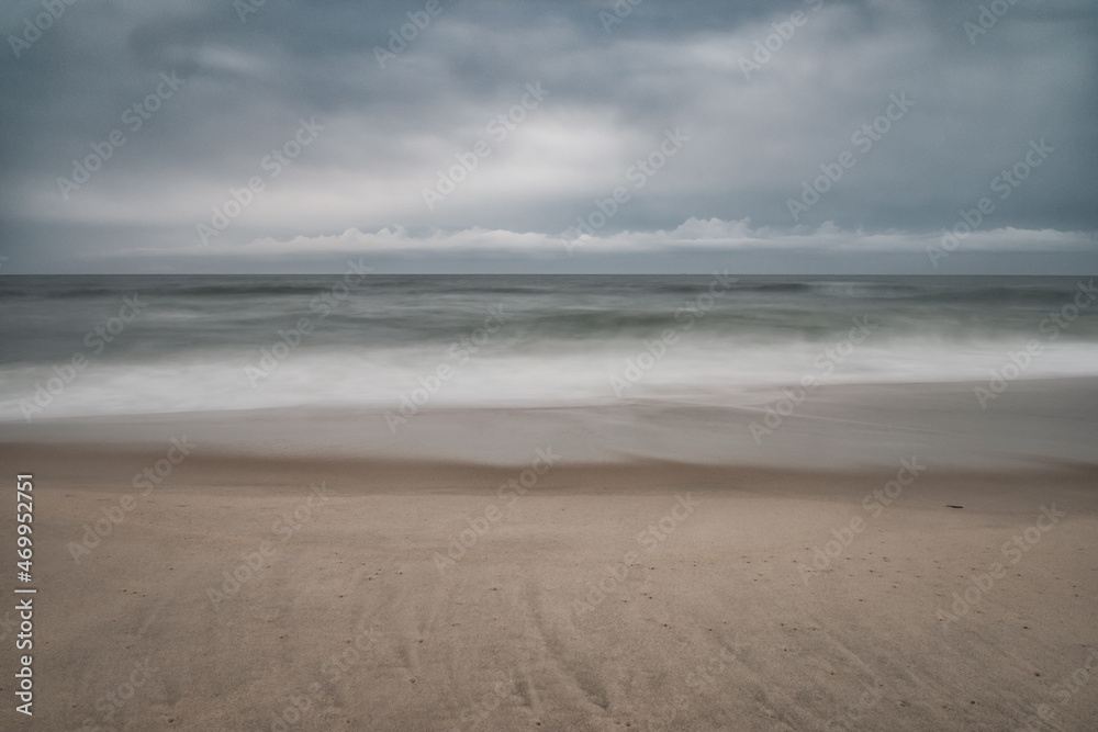 Soft focus beach foam rolls onto an empty beach during an Atlantic storm Soft focus beach foam rolls onto an empty beach during an Atlantic storm