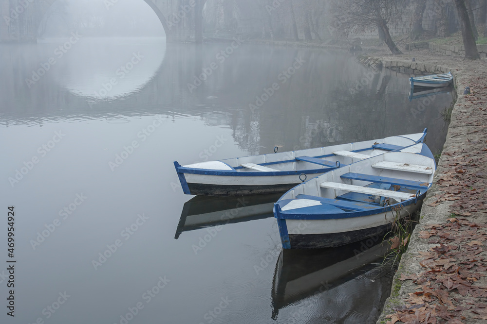 Traditional river wooden boats in the fog Traditional river wooden boats in the fog