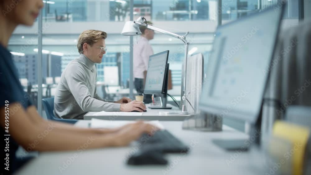 Big Diverse Corporate Office: Portrait of Handsome Manager Using Desktop Computer, Businessman Managing Company Operations, Analysing Statistics, Commerce Data, Marketing Plans. Zoom In Shift Focus.