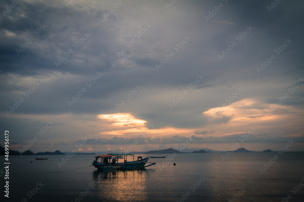 A fishing boat is seen waiting for the sun to set in the waters of Labuan Bajo, East Nusa Tenggara, Indonesia, to start fishing activities.