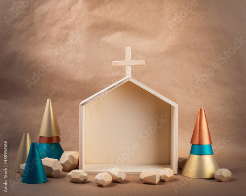 Minimal wooden Church and paper treess on brown paper background. DIY organic sustainable Christmas decoration. photo