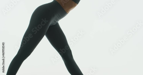 Yoga practice, close up of flexible girl doing Parshvottanasana Intense Side Stretch Pose on white studio background