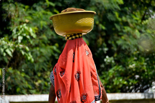 Photography Asian Woman carrying vegetables in head for sell