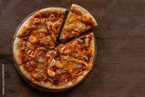 Pieces of pizza being separated from the tray.