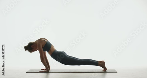 Yogi girl practicing yoga exercising perform downward dog and cobra pose, stretching body muscles for wellness