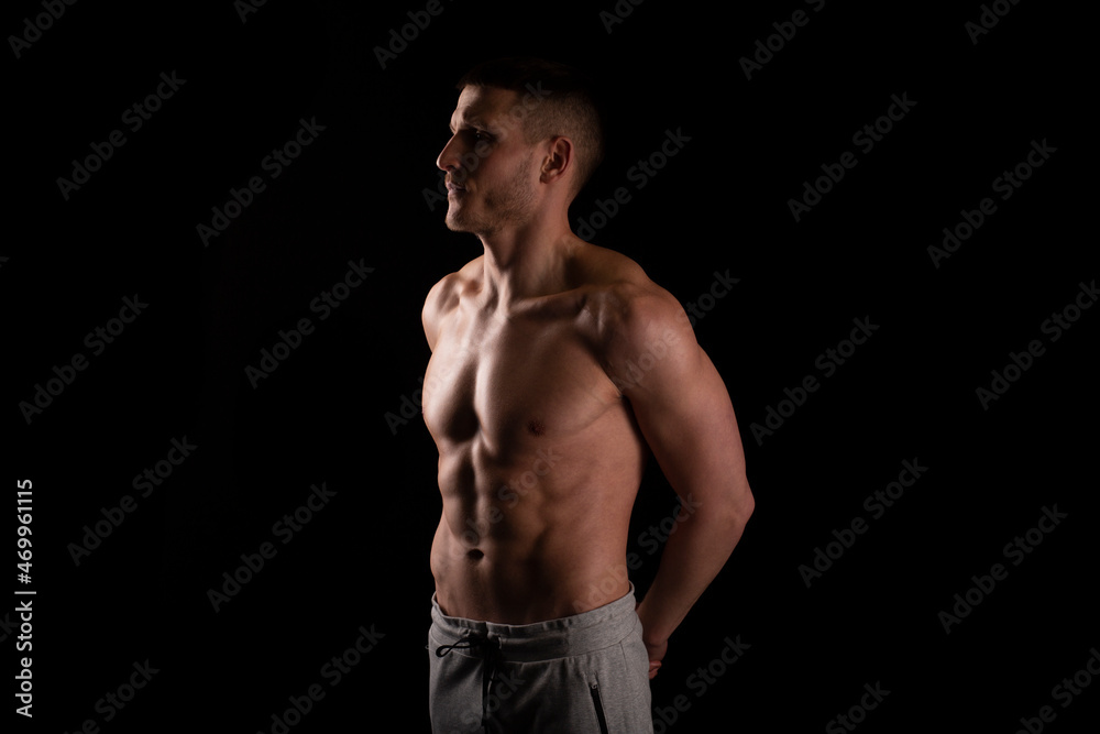 Man Showing ABS. Muscle man Posing. Strong Body Concept. Topless Sport man Bodybuilder. Six Pack Spotsman. Hands Behind Back