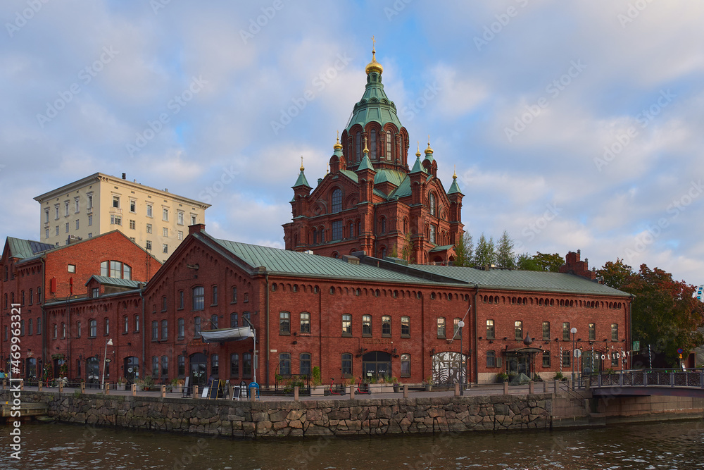 Buildings in the Katajanokka district in Helsinki:  autumn, church, red brick, old historic building, blue beautiful sky.