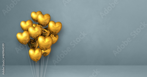 Gold heart shape balloons bunch on a grey wall background. Horizontal banner.