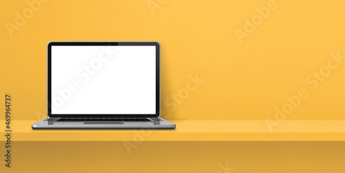 Laptop computer on yellow shelf background banner