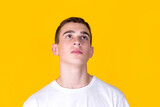 A handsome guy in a white t-shirt  on a yellow background
