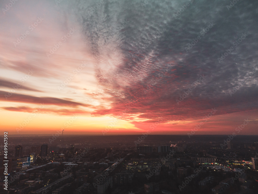 Aerial scenic vivid colorful sunset view with epic skyscape. Moody Kharkiv city center, Pavlove pole residential district streets in evening light