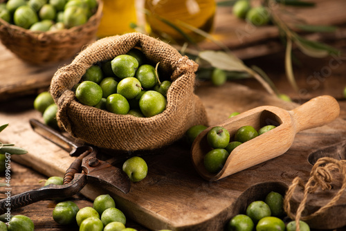 Extra virgin olive oil with fresh green olives