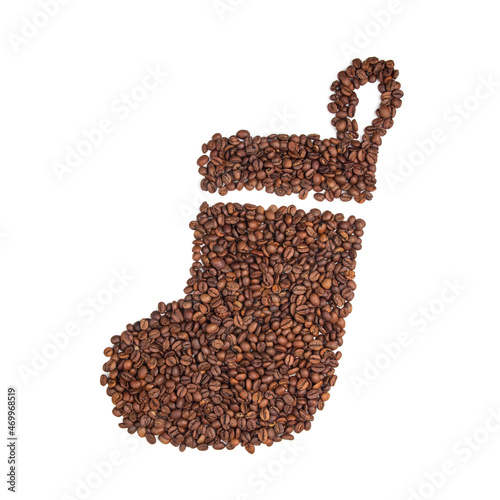 Contour of a Christmas stocking made of coffee beans on a white isolated background. Christmas gifts concept. Flat lay. Details of registration.