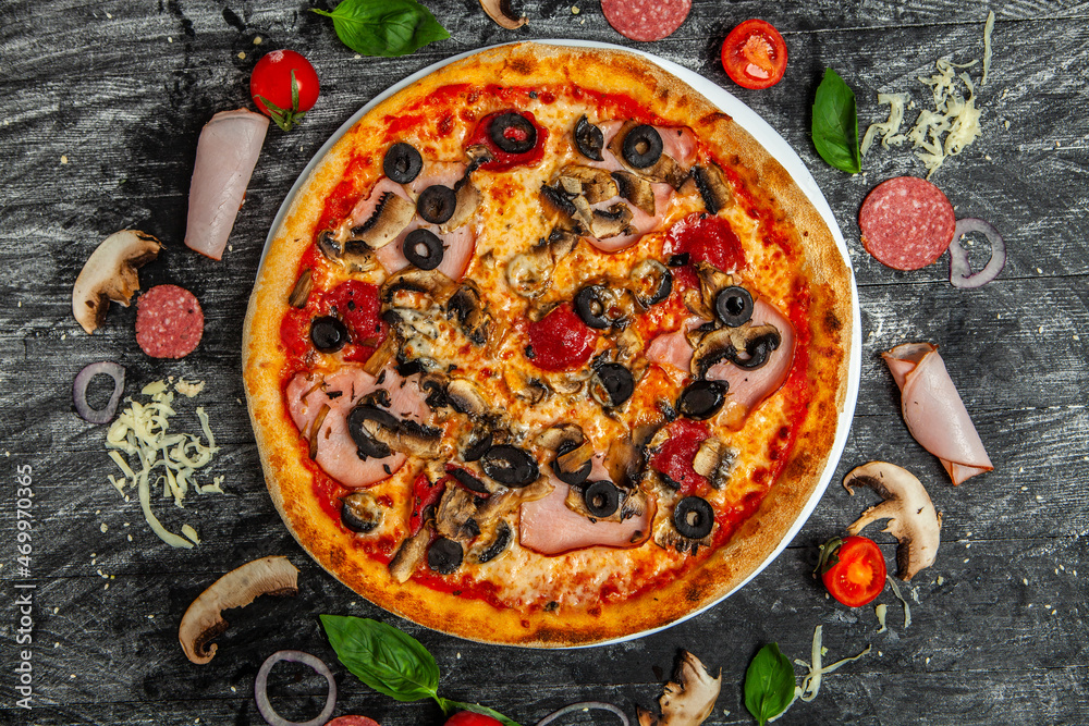 Pizza Quatro stagione with tomato sauce, salami, mushrooms, mozzarella, bacon, olives.