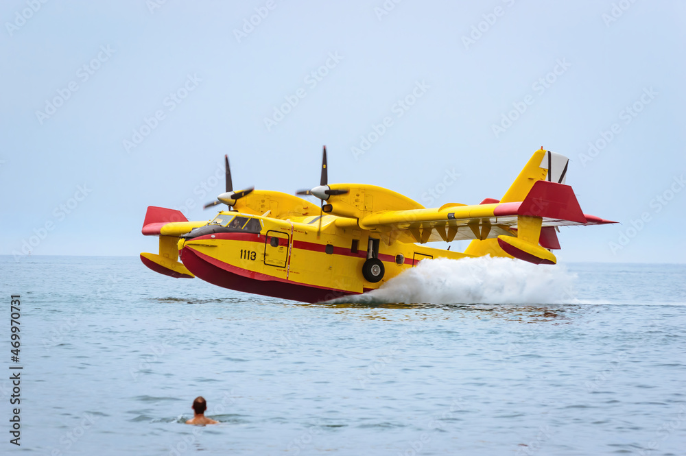 Firefighting seaplane collecting water in the sea. Firefighting seaplane collecting water in the sea.